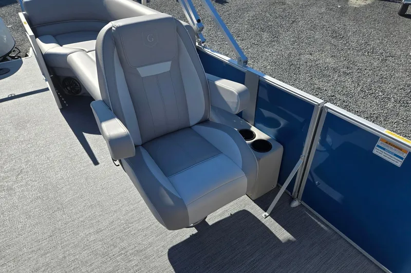 Slide: The Image of 2026 Godfrey Xperience 2286 SBX boat seat with cup holders, gray upholstery, and blue paneling. - 14