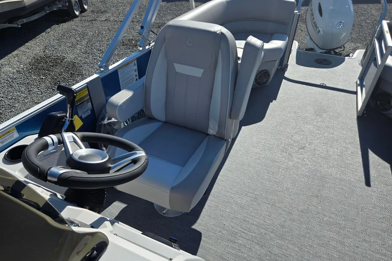 Slide: The Image of 2026 Godfrey Xperience 2286 SBX boat interior with steering wheel and seating. - 15