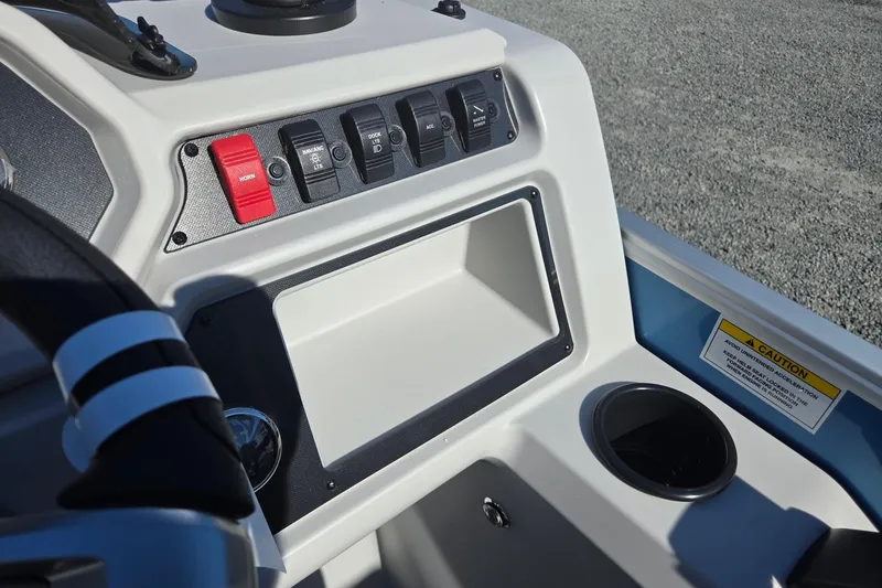 Slide: The Image of 2026 Godfrey Xperience 2286 SBX boat dashboard with switches and storage compartment. - 20