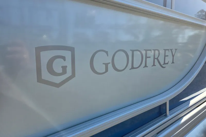 Slide: The Image of 2026 Godfrey Xperience 2286 SBX logo on boat exterior. - 39