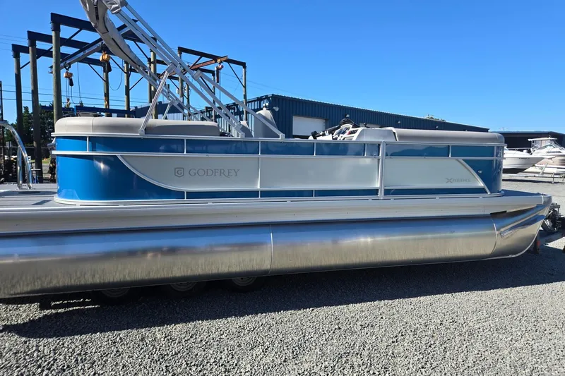 Slide: The Image of 2026 Godfrey Xperience 2286 SBX pontoon boat in a marina setting. - 6