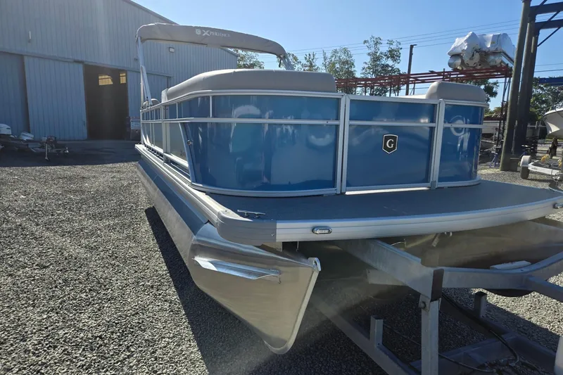 Slide: The Image of 2026 Godfrey Xperience 2286 SBX pontoon boat in a boatyard setting. - 8