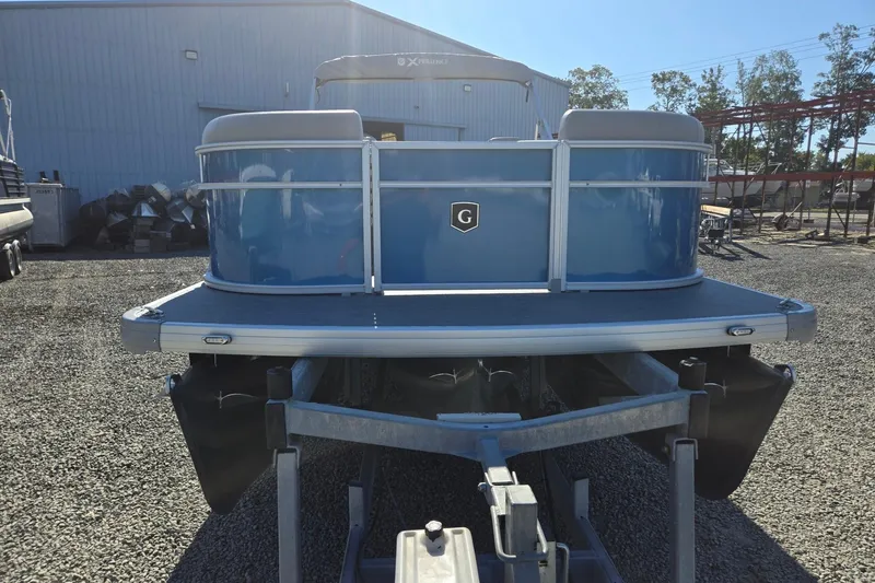 Slide: The Image of 2026 Godfrey Xperience 2286 SBX pontoon boat on trailer, blue exterior, outdoor setting. - 9