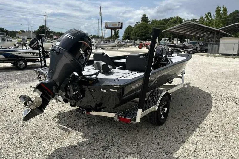 Slide: The Image of 2026 Xpress H18 Bay boat on trailer with Yamaha outboard motor in a dealership lot. - 12