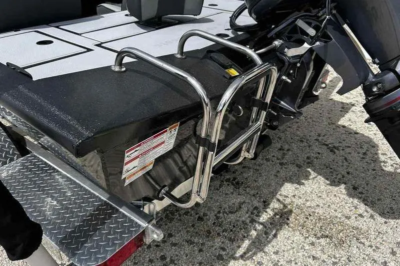 Slide: The Image of 2026 Xpress H18 Bay boat rear view with metal ladder and textured flooring. - 13