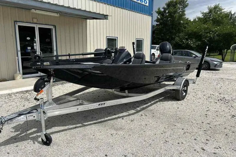 Slide: The Image of 2026 Xpress H18 Bay boat on trailer outside a building, ready for transport. - 3