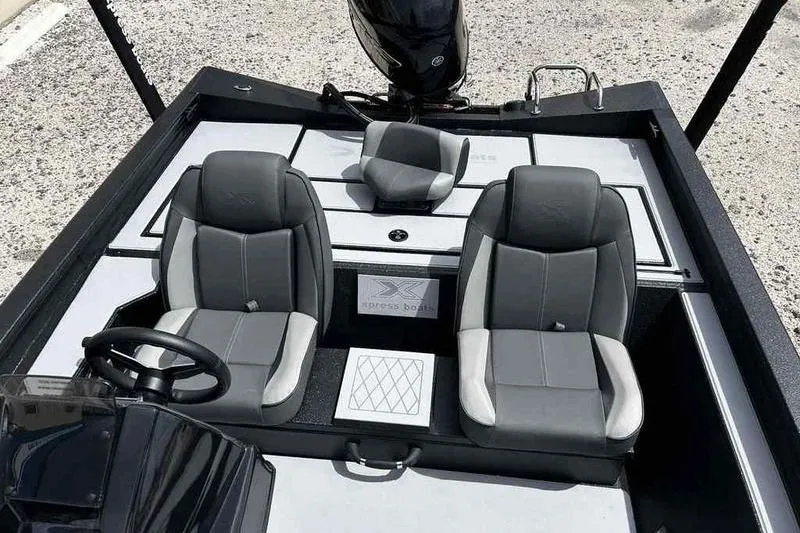 Slide: The Image of 2026 Xpress H18 Bay boat interior with gray seating and steering wheel. - 6
