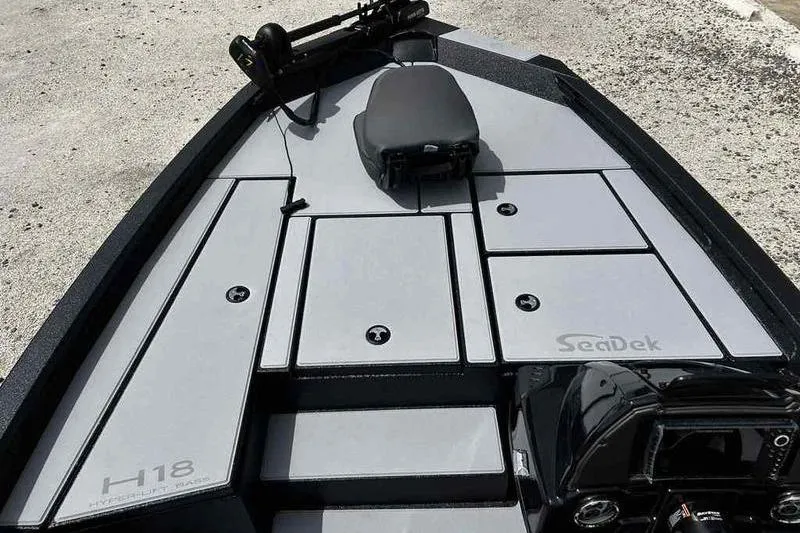 Slide: The Image of 2026 Xpress H18 Bay boat deck with SeaDek flooring and storage compartments. - 8