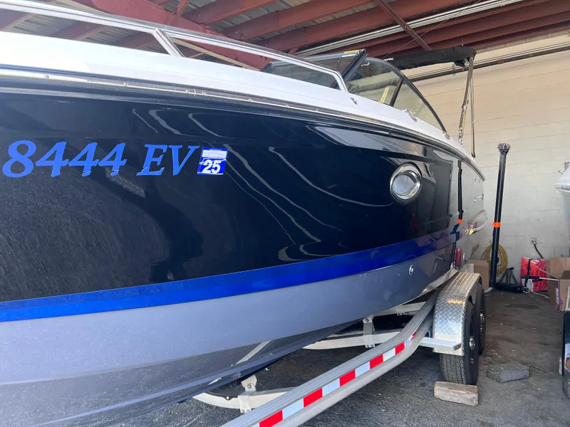 Slide: The Image of 2022 Chaparral 267 SSX boat on trailer in storage facility. - 11