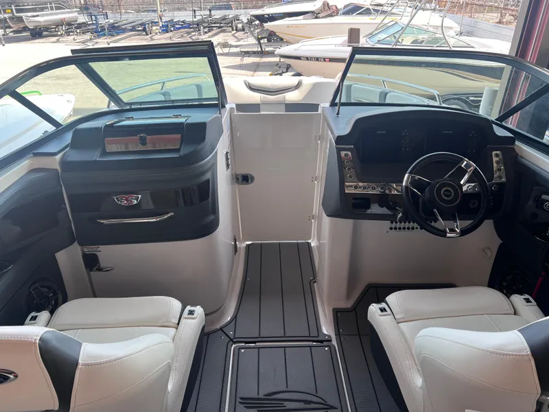 Slide: The Image of 2022 Chaparral 267 SSX boat interior with dual captain seats and modern dashboard. - 15
