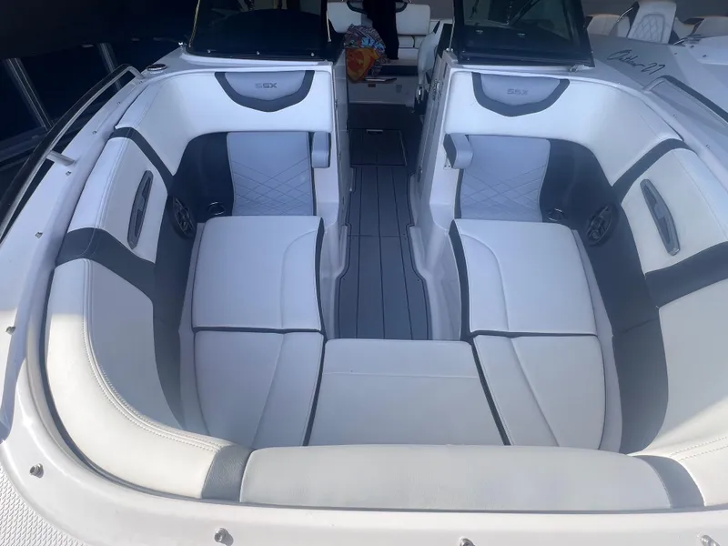 Slide: The Image of 2022 Chaparral 267 SSX boat interior with white and gray seating. - 16