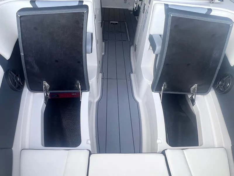 Slide: The Image of 2022 Chaparral 267 SSX boat interior with open storage compartments. - 17