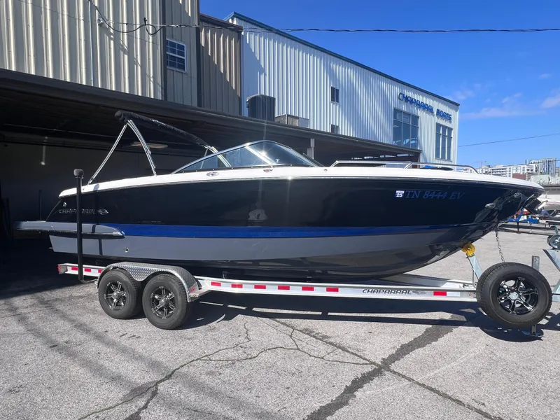 Slide: The Image of 2022 Chaparral 267 SSX boat on a trailer outside a warehouse. - 2