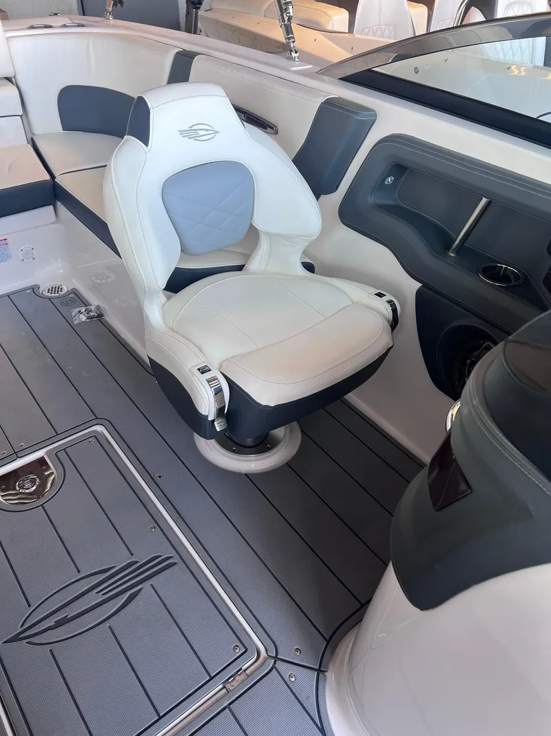 Slide: The Image of 2022 Chaparral 267 SSX boat interior with white and gray seating. - 23