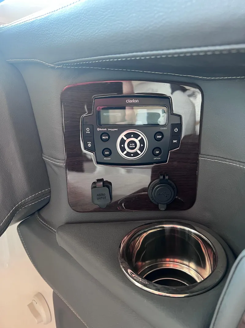 Slide: The Image of Control panel and cup holder in 2022 Chaparral 267 SSX boat. - 24