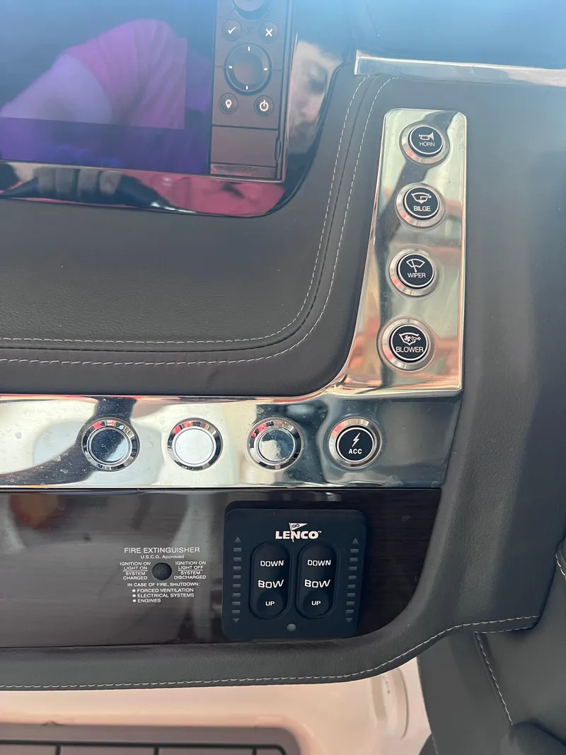 Slide: The Image of Control panel of a 2022 Chaparral 267 SSX boat with Lenco trim tab switches. - 25