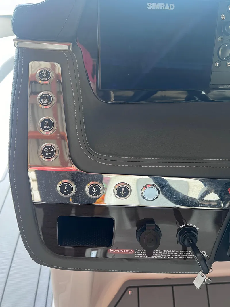 Slide: The Image of Control panel of a 2022 Chaparral 267 SSX boat with Simrad display. - 26