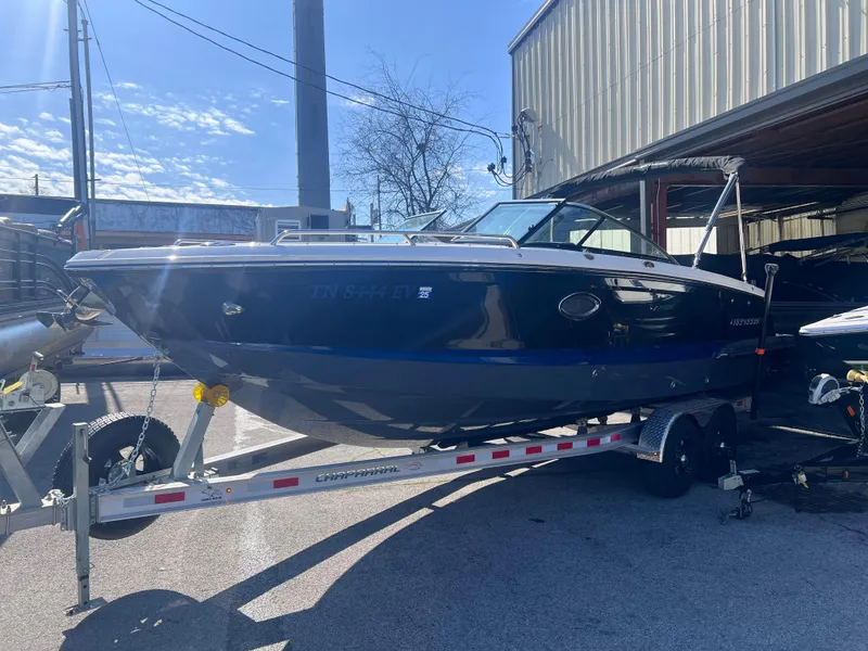 Slide: The Image of 2022 Chaparral 267 SSX boat on a trailer in a sunny outdoor setting. - 3