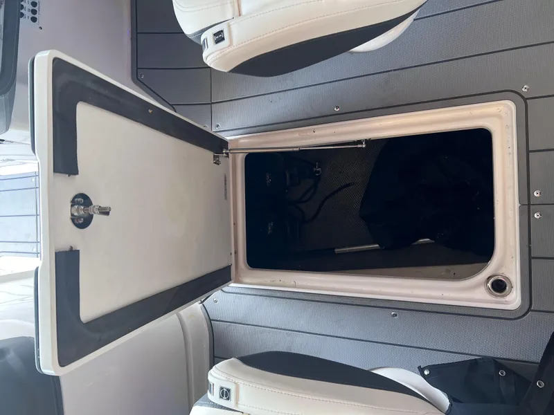 Slide: The Image of Open storage compartment on a 2022 Chaparral 267 SSX boat. - 31
