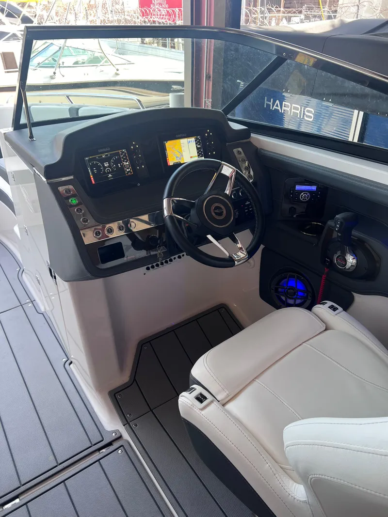 Slide: The Image of 2022 Chaparral 267 SSX boat cockpit with modern dashboard and steering wheel. - 32