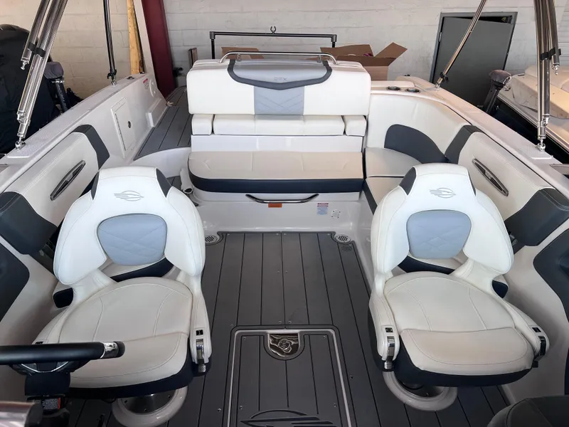 Slide: The Image of 2022 Chaparral 267 SSX boat interior with white and gray seating. - 33