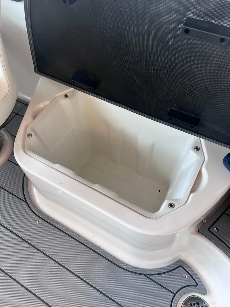 Slide: The Image of Open storage compartment on a 2022 Chaparral 267 SSX boat. - 35