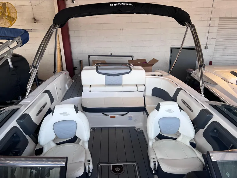 Slide: The Image of 2022 Chaparral 267 SSX boat interior with white and gray seating. - 38