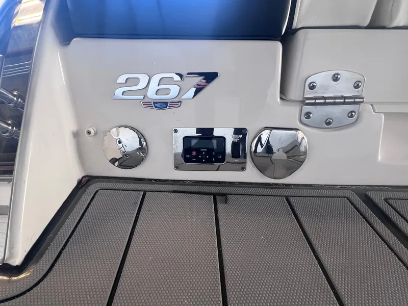 Slide: The Image of 2022 Chaparral 267 SSX boat rear deck with control panel and logo. - 43