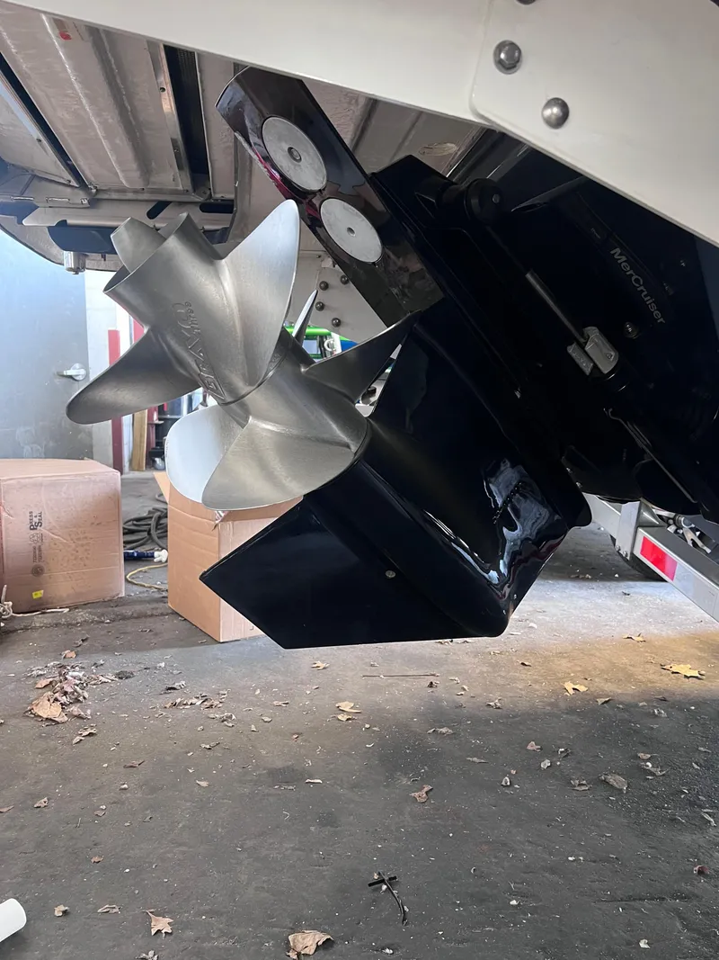 Slide: The Image of 2022 Chaparral 267 SSX boat propeller and stern drive in a garage setting. - 49