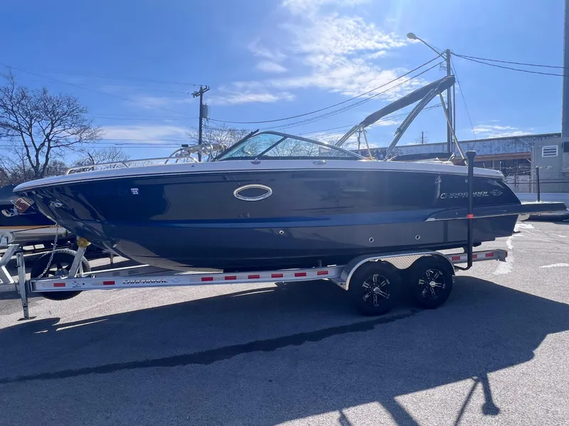 Slide: The Image of 2022 Chaparral 267 SSX boat on a trailer in a parking lot. - 5