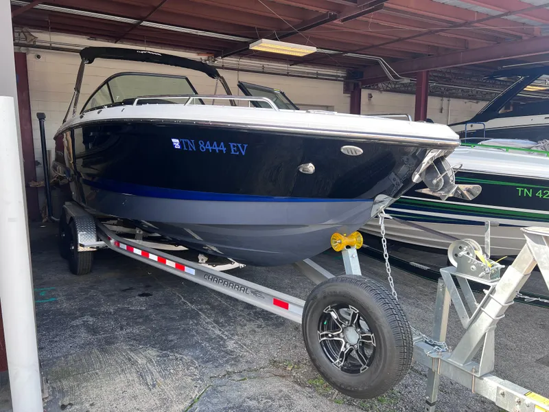 Slide: The Image of 2022 Chaparral 267 SSX boat on a trailer in a covered storage area. - 8