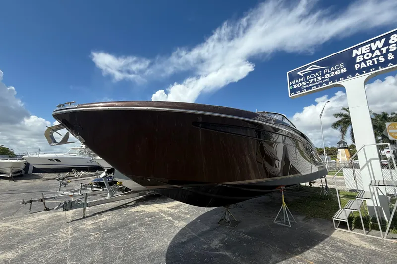 Slide: The Image of 2005 Riva RivaRama 44 luxury yacht displayed at Miami Boat Place under a clear blue sky. - 30