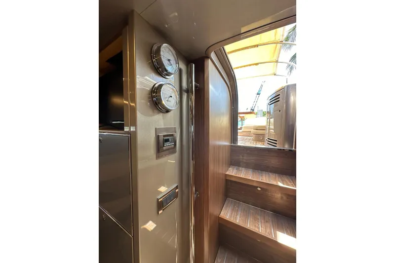 Slide: The Image of Interior view of 2005 Riva RivaRama 44 yacht, featuring wooden stairs and control panel. - 2