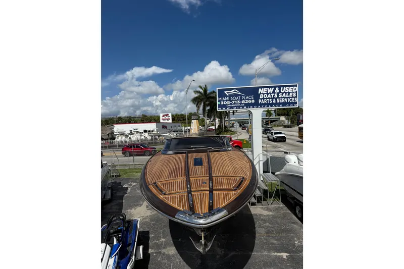 Slide: The Image of 2005 Riva RivaRama 44 boat displayed at Miami Boat Place under a clear blue sky. - 29