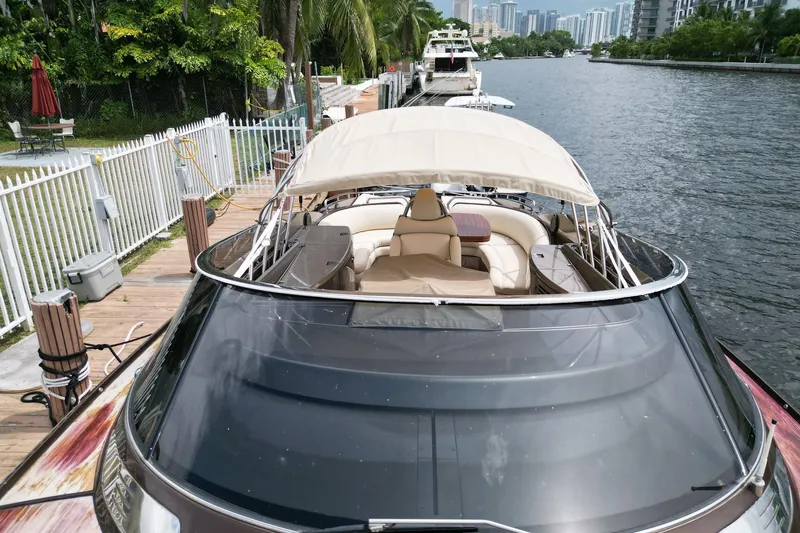 Slide: The Image of Luxury 2005 Riva RivaRama 44 yacht docked by a scenic waterfront. - 3