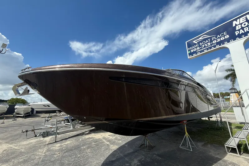 Slide: The Image of 2005 Riva RivaRama 44 luxury yacht displayed at Miami Boat Place under a clear blue sky. - 32