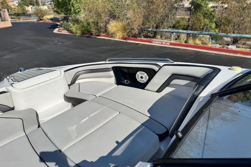 Slide: The Image of 2020 Yamaha AR240 boat interior with cushioned seating and speaker system. - 16