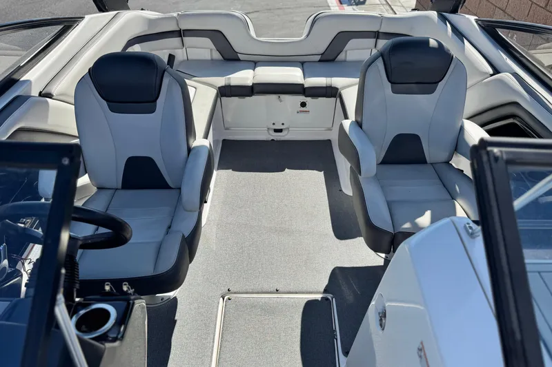 Slide: The Image of 2020 Yamaha Boats AR240 interior with dual captain's chairs and spacious seating area. - 17