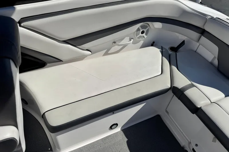 Slide: The Image of Interior seating of a 2020 Yamaha Boats AR240, featuring sleek white and gray upholstery. - 19