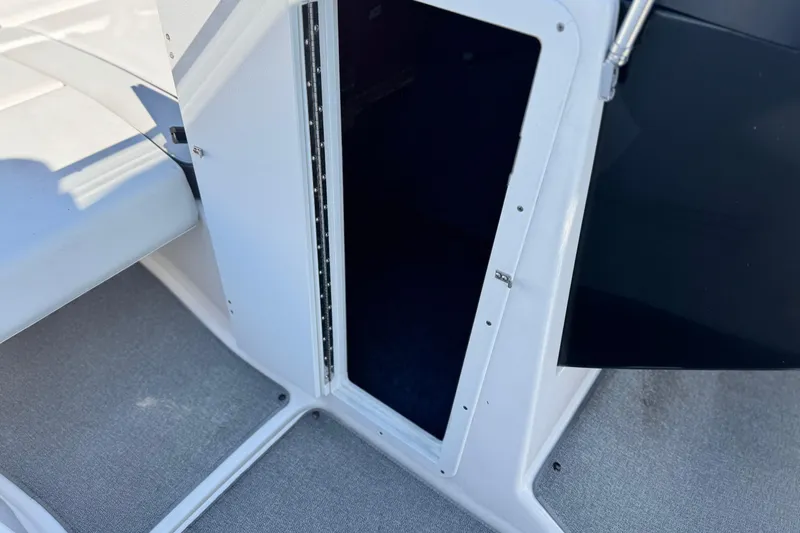 Slide: The Image of 2020 Yamaha AR240 boat storage compartment with open door, showcasing interior space. - 38