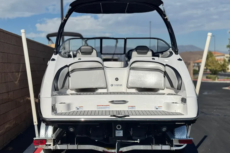 Slide: The Image of 2020 Yamaha Boats AR240, rear view, on trailer, showcasing seating and swim platform. - 4