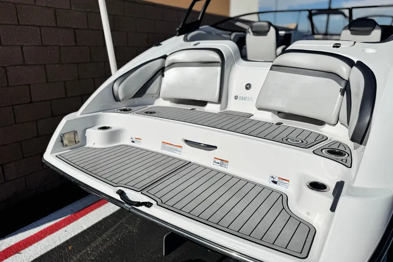 Slide: The Image of 2020 Yamaha AR240 boat rear deck with seating and cup holders. - 6