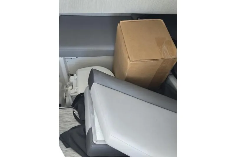 Slide: The Image of 2021 Cobalt A29 interior storage with cardboard box and seat cushions. - 11