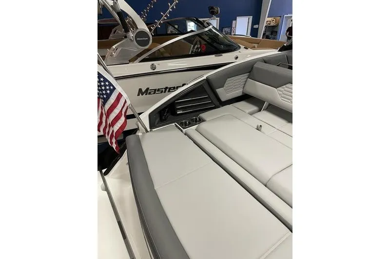 Slide: The Image of 2021 Cobalt A29 boat interior with American flag and luxury seating. - 13
