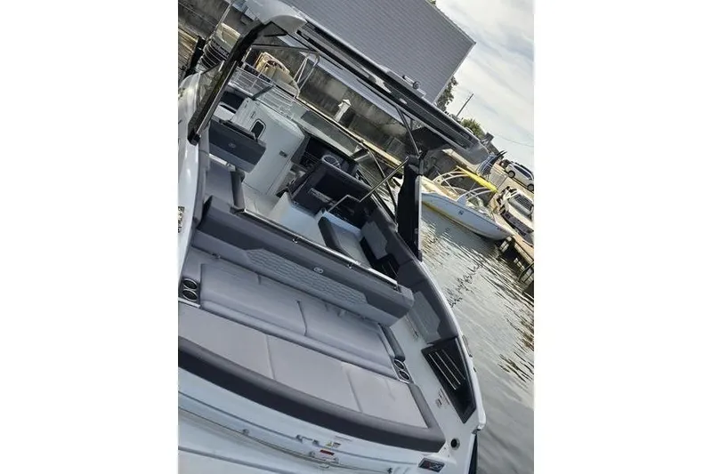 Slide: The Image of 2021 Cobalt A29 boat with sleek interior design docked at marina. - 14