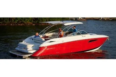 Slide: The Image of 2021 Cobalt A29 boat with red hull cruising on a lake. - 2