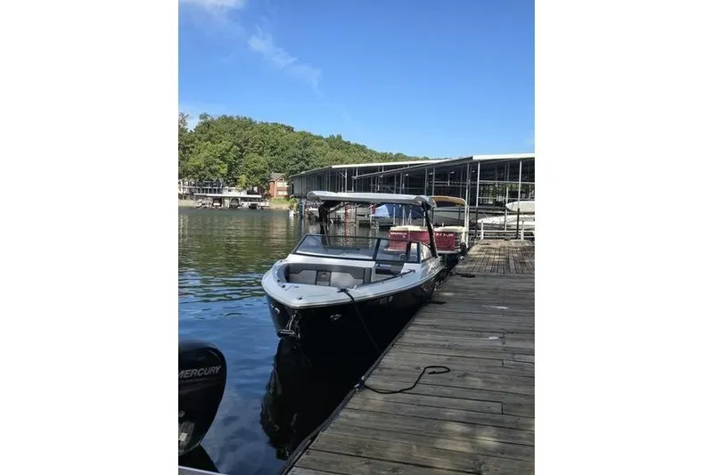 Slide: The Image of 2021 Cobalt A29 boat docked at a marina on a sunny day. - 5