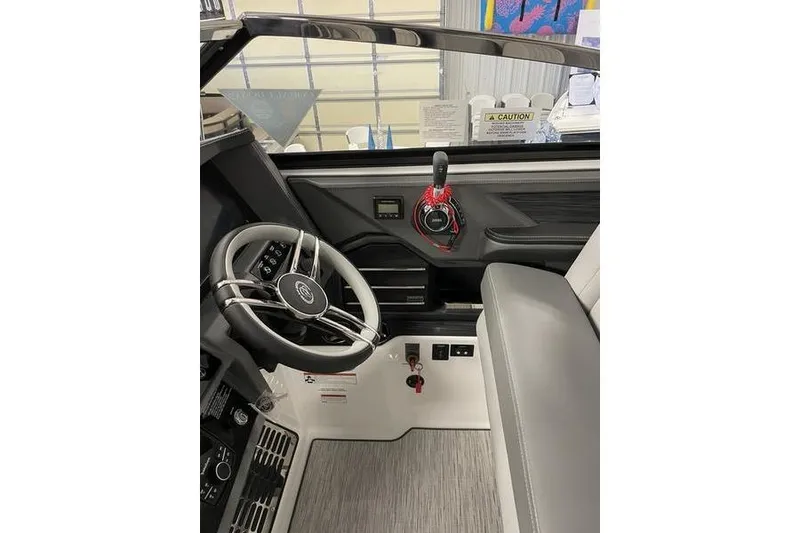 Slide: The Image of 2021 Cobalt A29 boat interior with steering wheel and control panel. - 9