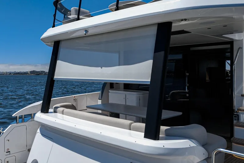 Slide: The Image of 2026 Azimut Fly 72 yacht with shaded outdoor seating area on the water. - 35