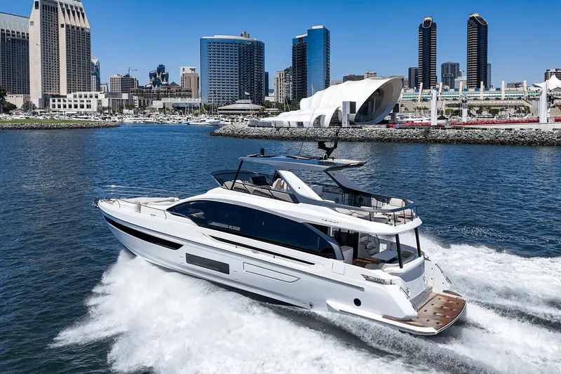 Slide: The Image of 2026 Azimut Fly 72 yacht cruising near city skyline, clear blue sky. - 4